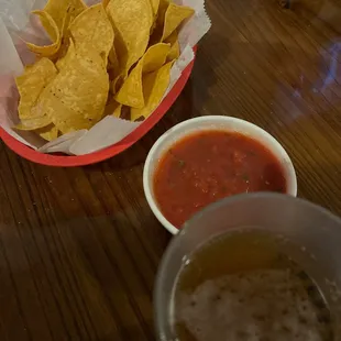a bowl of chips and a bowl of salsa