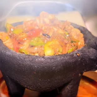 Volcano Plate
 A combination of Beef, Chicken, and Shrimp cooked with Vegetables Topped with Cheese and Ranchera Sauce,
