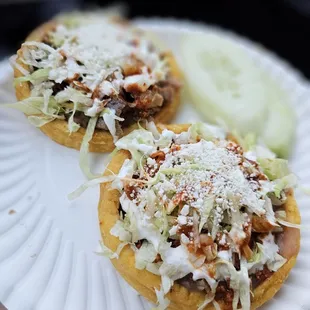 two tacos on a paper plate