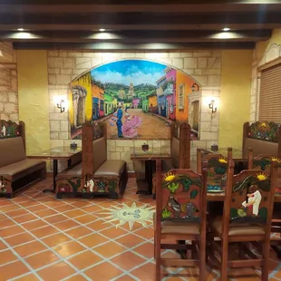 a dining room with a mural on the wall