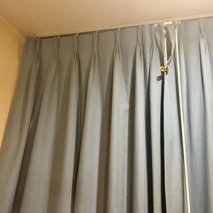 Curtains that are broken at the top and had to be clipped to stay shut