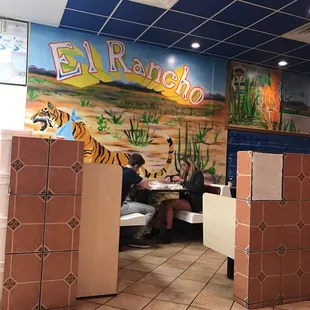 two people sitting at a table in a restaurant