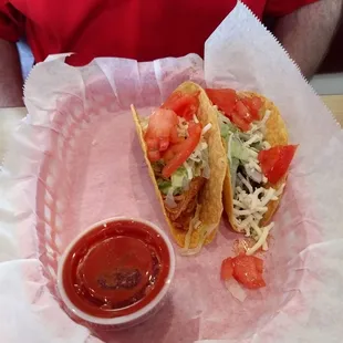 Two tacos, steak and chicken.