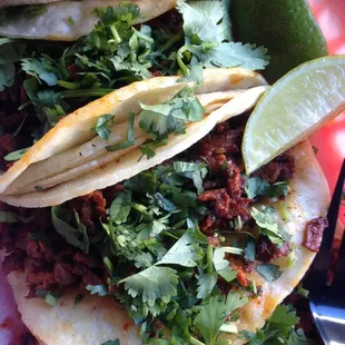 Tacos el pastor with cilantro and limes in a corn tortilla. (Not sure if this is on the menu, I asked for it. )