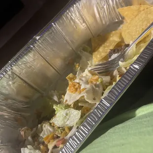 Burrito with toppings and chips.