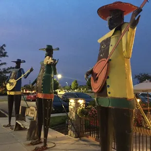 a statue of a man with a guitar and a guitar player