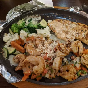 a plate of food with shrimp and vegetables