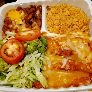 Enchiladas: Corn tortillas, rice, beans, guacamole, and salad, Pollo en Salsa (Chicken with Sauce &amp; Spices), no sour cream ($18.95)