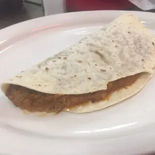 This is a small bean chorizo taco.
