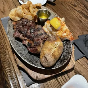 Ribeye &amp; lobster, onion rings, baked potato