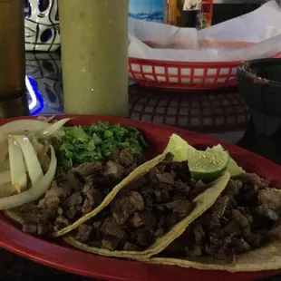 a plate of tacos and a beer