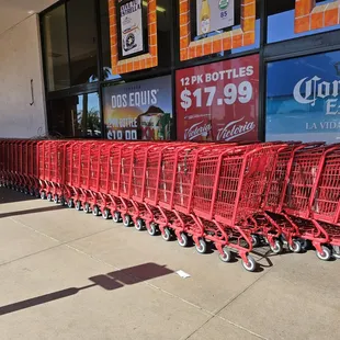 red shopping carts lined up in front of a store