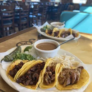 a plate of tacos and a bowl of sauce