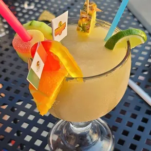 a cocktail with fruit garnish