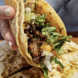 Amazing Al Pastor taco, with equally delicious quesadilla at the backdrop.