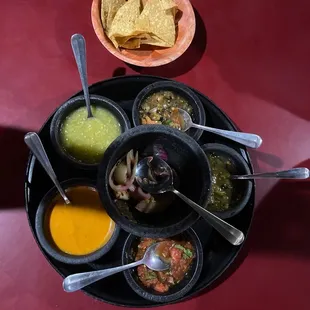 a plate of mexican food with tortillas and salsa