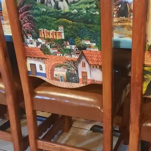 a dining room table with a painting on it