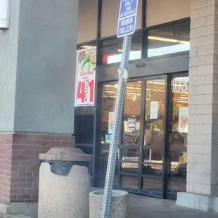 a street sign in front of a store