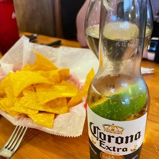 a bottle of beer and chips