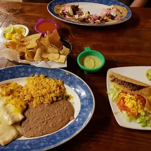 Shrimp Enchilada dinner with a taco filled with ground beef, rice, refried beans, and a cheese puff on the side!