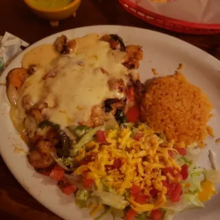 Pollo Del Mar! (Chicken breast topped with creamy seafood sauce, crawfish tails, and baby shrimp served with taco salad and a side of rice!)