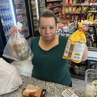 a woman holding a bag of food