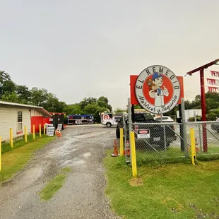 Entrance, which can easily be missed but looks like it's in the lot of an old auto car lot.