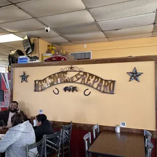people sitting at tables in a restaurant