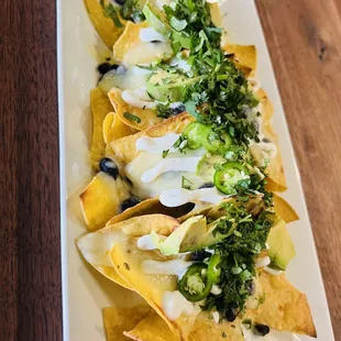 House nachos / Black beans or refried
beans,cheese,avocado,fresh jalapeño,sour cream, cilantro