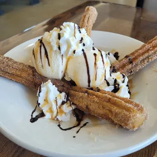 a plate of ice cream and churros