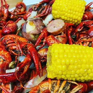 a platter of crawfish and corn