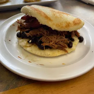 Arepa with shredded beef, black bean and plantains