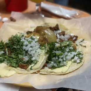 two tacos with onions and herbs