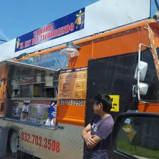 a man standing in front of a food truck