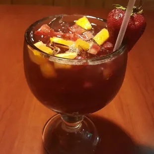 a glass of fruit punch on a table