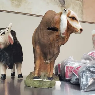 two figurines of a cow and a goat