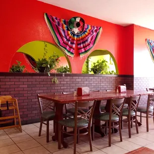 a dining area with a table and chairs