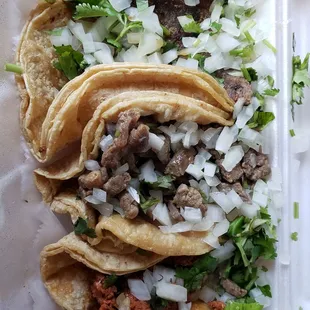 two tacos in a styrofoam container