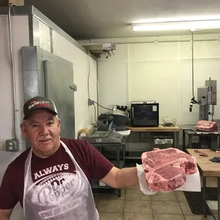 a man holding a piece of meat