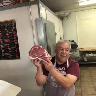 a man holding a piece of meat