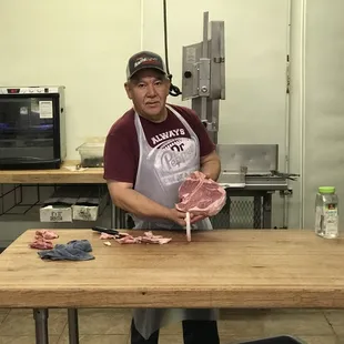 a man holding a piece of meat