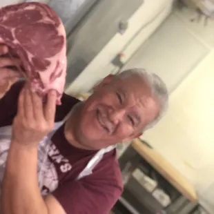 a man holding a piece of meat