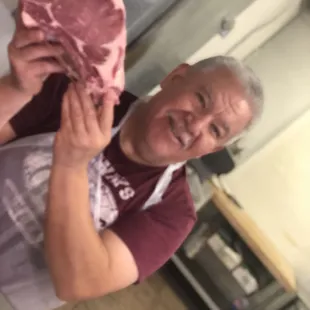 a man holding a piece of meat
