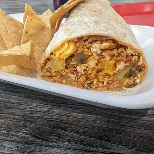 Breakfast chorizo and egg with papas burrito .