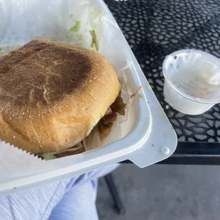 Carnitas Torta with the $1.50 per blop of sour cream