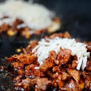 meat and cheese being cooked