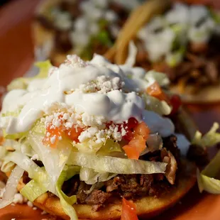 two tacoss on an orange plate