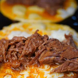 a closeup of a beef taco on a tortilla