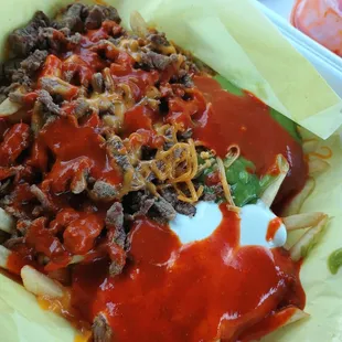 Carne asada fries with red sauce.