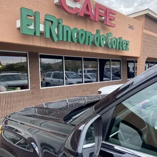 a car parked in front of a cafe